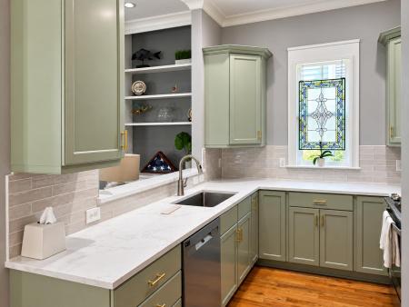 Polished sage green kitchen with stained glass