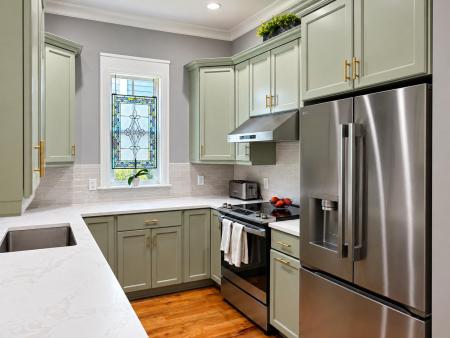 Finished sage green kitchen cabinets painted by Paragon Painting in Summerville SC.